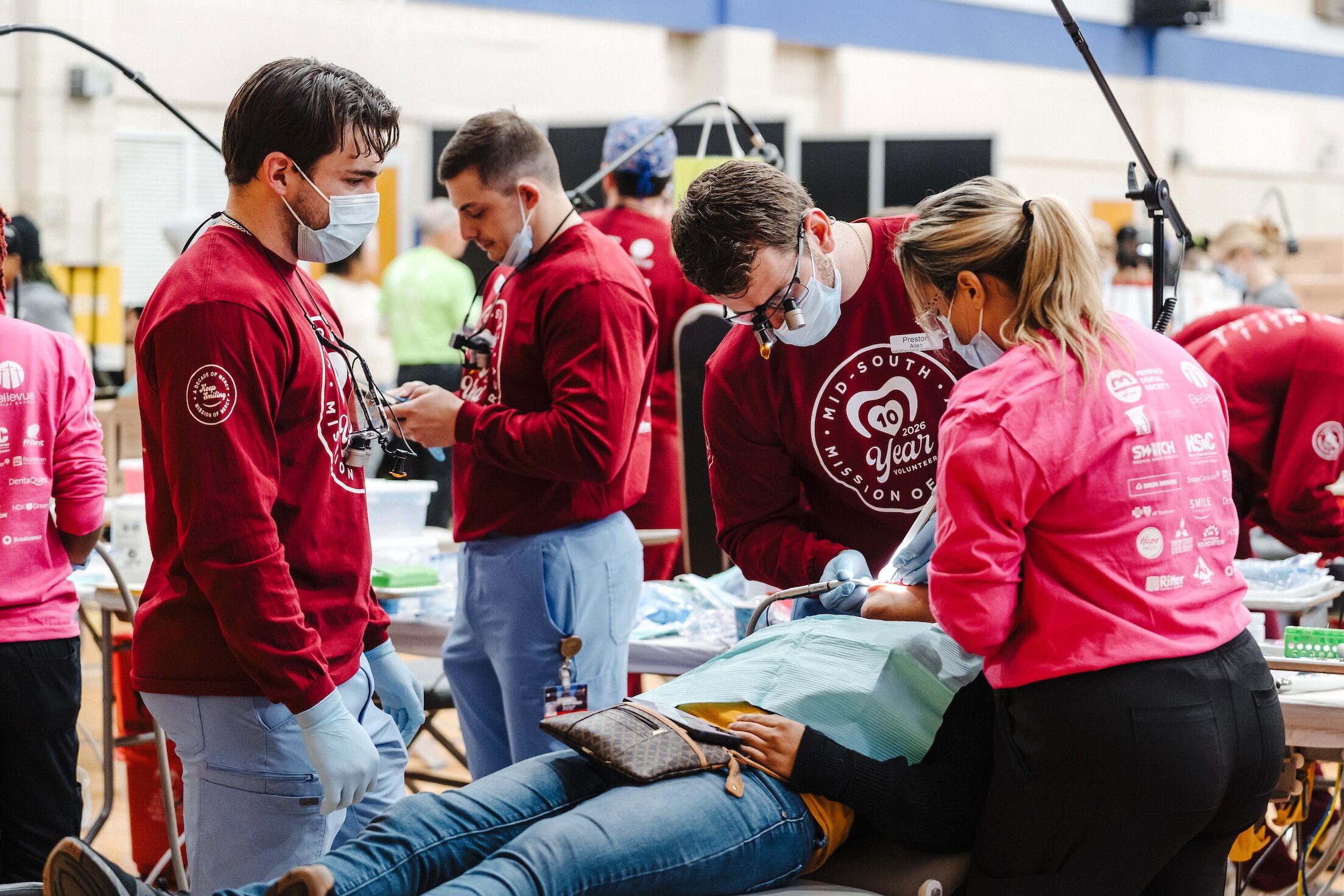 Volunteers working with a patient
