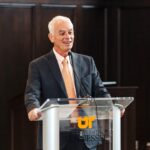 Chancellor Peter Buckley speaking joyfully at a podium